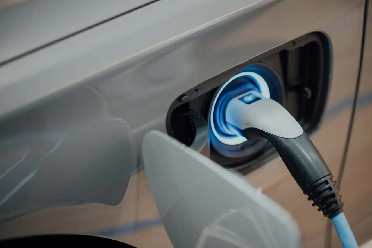 Elektroauto lädt an einer Wallbox an einer Hauswand – Symbolbild