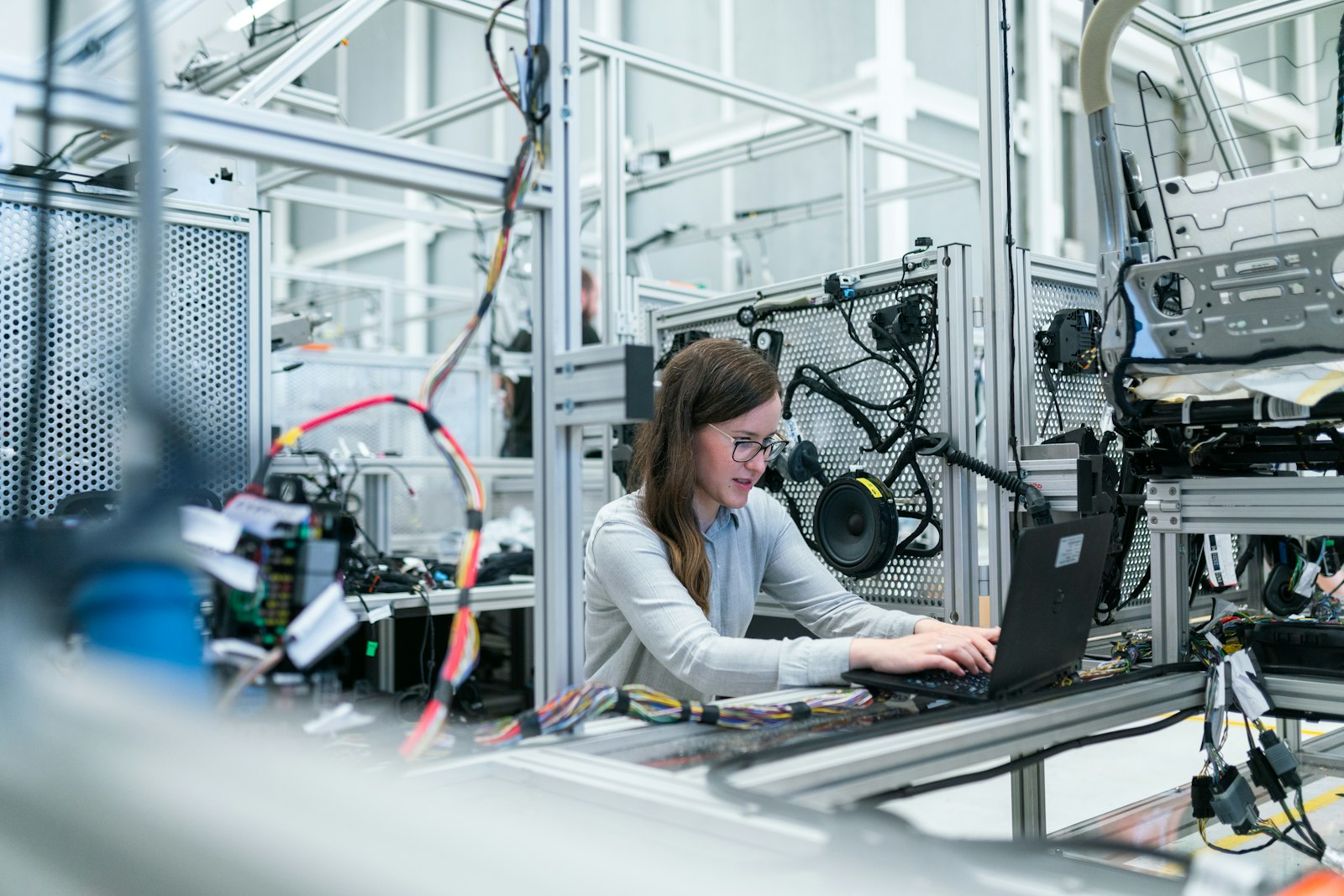 Elektrotechnikerin in einer Fertigungshalle